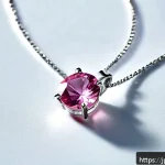 스와로브스키 목걸이 라인업 - A close-up image of a delicate Swarovski necklace featuring a slender silver chain with a single spa...
